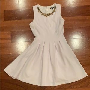white dress with gold and black jeweled neckline